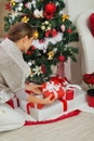 Woman putting Christmas present box