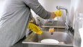 Young woman putting clean wet dish in dryer on kitchen Royalty Free Stock Photo