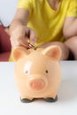 Woman putting coin into piggy bank Royalty Free Stock Photo