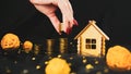 Woman putting coins in pile for as saving for house. Crop anonymous female collecting coins in pile for real estate