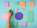 Woman putting color paper arrows