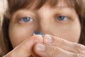 Woman putting contact lens (selective focus used) Royalty Free Stock Photo