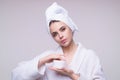 Woman putting cosmetic cream. Spa model applying skincare product on her face. Morning make-up. Moisturizing skincare Royalty Free Stock Photo