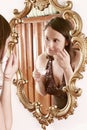 Woman putting cream in front of a mirror