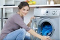 woman putting dirty laundry into washing machine Royalty Free Stock Photo