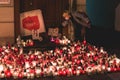 Lublin, Poland - October 23, 2020 - Woman putting down the banner among candles during protest against abortion ban in Poland