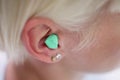 Woman Putting Earplug Into Her Ear Royalty Free Stock Photo