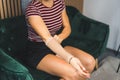 woman putting an elastic brace on her hand at home, injuries and self-treatment Royalty Free Stock Photo