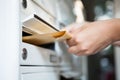 Woman putting envelope in mailbox