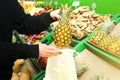 Woman is putting fruit in reusable shopping bag. Ecologically and environmentally friendly packets. Canvas and linen fabrics. Save Royalty Free Stock Photo