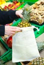 Woman is putting fruit in reusable shopping bag. Ecologically and environmentally friendly packets. Canvas and linen fabrics. Save Royalty Free Stock Photo