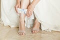 Woman putting on garter, her wedding day Royalty Free Stock Photo