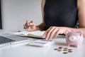 Woman putting golden coin in pink piggy bank for step up growing business to profit and saving with piggy bank, Saving money for Royalty Free Stock Photo