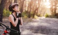 Woman putting helmet on for cycling Royalty Free Stock Photo