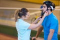 Woman putting helmet to cyclist Royalty Free Stock Photo