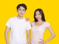 Woman putting her hand on male shoulder.Isolated on yellow background Royalty Free Stock Photo