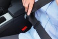 Woman putting on her seat belt