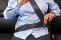 Woman putting on her seat belt