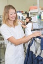 Woman putting jacket on hanger