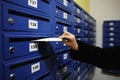 Woman putting letter into mailbox Royalty Free Stock Photo