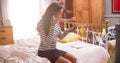 Woman Putting On Make Up And Man Getting Dressed In Bedroom Royalty Free Stock Photo