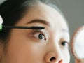 Woman is putting make up mascara on her eyelashes. Royalty Free Stock Photo