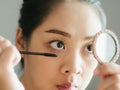 Woman is putting make up mascara on her eyelashes. Royalty Free Stock Photo