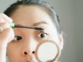 Woman is putting make up mascara on her eyelashes. Royalty Free Stock Photo