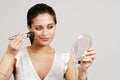 Woman putting on makeup with blush brush Royalty Free Stock Photo