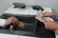 Woman putting money on card in bank, closeup. Currency exchange