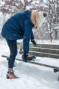 Woman putting non slip snow cleats on boots for winter hike Royalty Free Stock Photo