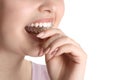 Woman putting occlusal splint in mouth on white background, closeup Royalty Free Stock Photo