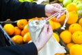 Woman is putting oranges in reusable shopping bag. Zero waste. Ecologically and environmentally friendly packets. Canvas and linen Royalty Free Stock Photo