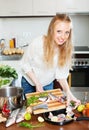 Woman putting pieces of fish into fryingpan Royalty Free Stock Photo