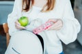 Woman putting daily pills organizer and apple into her bag. Taking daily medicine antioxidant diet vitamin supplements Royalty Free Stock Photo
