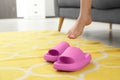 Woman putting on pink slippers indoors, closeup Royalty Free Stock Photo