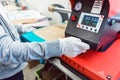 Woman putting print on a T-Shirt to make it a promotional item