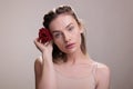 Woman putting red rose in blonde hair portrait Royalty Free Stock Photo