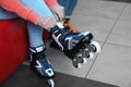 Woman putting on roller skates indoors Royalty Free Stock Photo