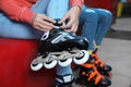 Woman putting on roller skates indoors Royalty Free Stock Photo