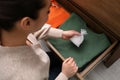 Woman putting scented sachet into drawer with clothes, above view