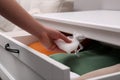 Woman putting scented sachet into drawer with clothes, closeup Royalty Free Stock Photo