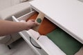 Woman putting scented sachet into drawer with clothes, closeup Royalty Free Stock Photo