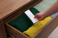 Woman putting scented sachet into drawer with clothes, closeup Royalty Free Stock Photo