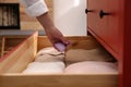 Woman putting scented sachet into drawer with clothes, closeup Royalty Free Stock Photo