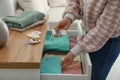 Woman putting scented sachet into drawer with clothes, closeup Royalty Free Stock Photo