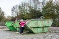 Woman putting scrap metal in container to be recycled Royalty Free Stock Photo