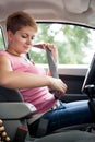 Woman putting seat belt