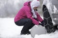 Woman putting snow chains Royalty Free Stock Photo