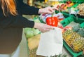 Woman is putting vegetables in reusable shopping bag. Ecologically and environmentally friendly packets. Canvas and linen fabrics Royalty Free Stock Photo